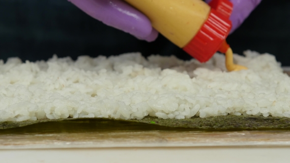 Sushi Master Pours a Sause The Foundation For Sushi. 