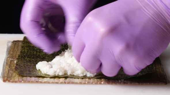 Chef Shapes The Rice On The Nori Sheet. 