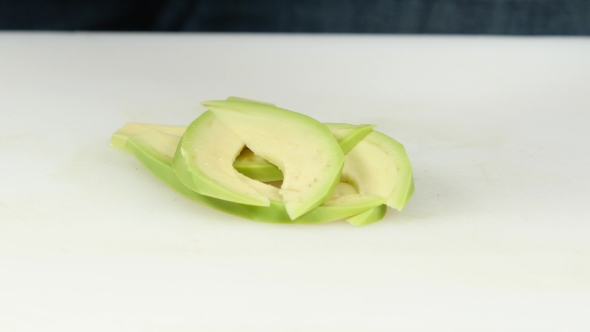 Cook Puts Sliced Of Avocado On The Table. 