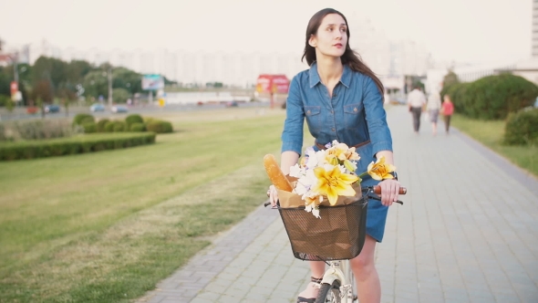 Brunette Girl Cycling With Flowers In a Basket And Exploring The City, , Steadicam Shot