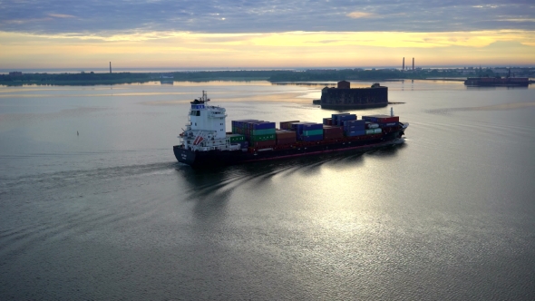 Aerial View Over Cargo Transport Ship Sailing On a Wide Lake In Summer Sunrise