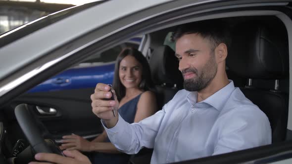 Happy Buyers Taking Key Sitting in New Auto