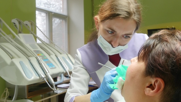 Woman Receiving A Dental Treatment