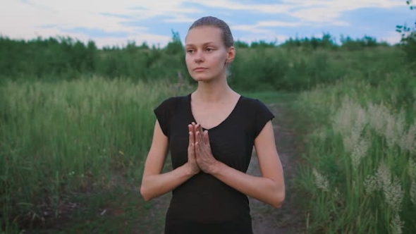 Inspired Woman Doing Yoga At a Field