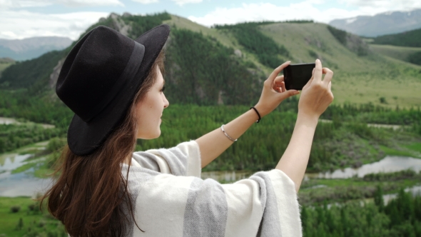 Woman Hiker Taking Photo With Smart Phone At Mountain Peak Cliff