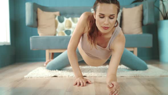 Close Up Young Pregnant Woman Practicing Yoga. Belly Mother Stretching on Floor