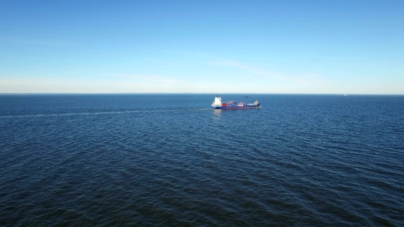 Aerial View Over Cargo Transport Ship Sailing On Sea alt
