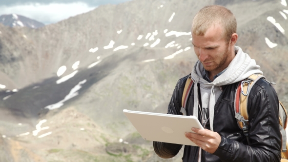 Man Working Outdoors With Tablet Computer