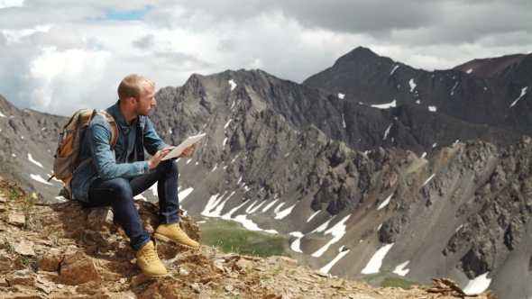 Man Working Outdoors With Tablet Computer