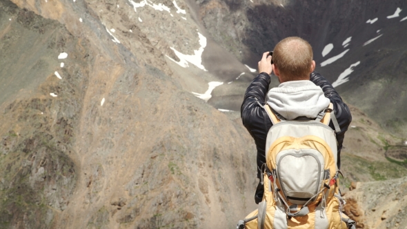 Tourist Takes Photos With Smart Phone On Peak Of Rock