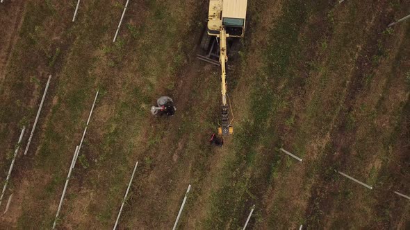 Excavator Hammers a Concrete Pillar