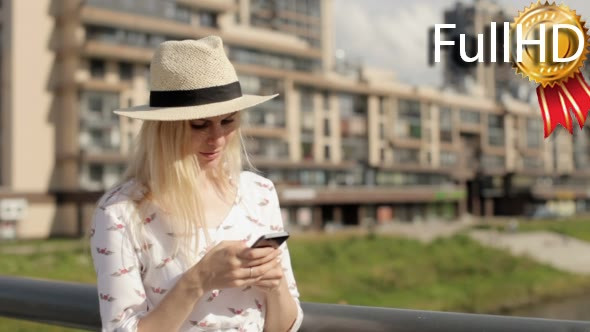 Woman Writes a Message on a Smartphone