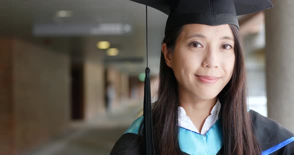 Woman with graduation gown in university gown