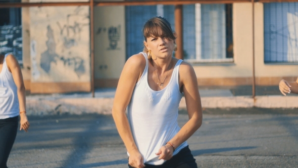 Girls In White T-shirts Dancing On The Playground In Summer