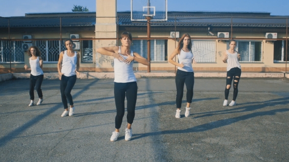 Girls In White T-shirts Dancing On The Playground In 