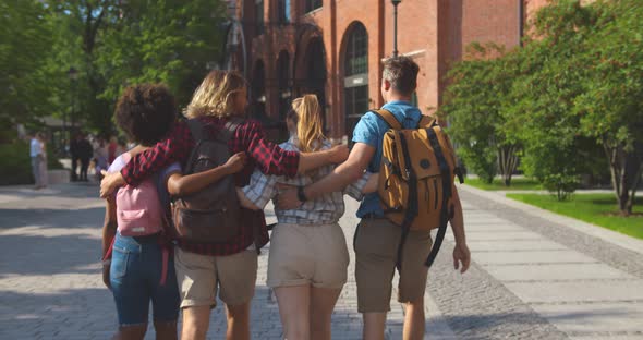 Follow Shot of Diverse Backpacker Walking in Foreign City