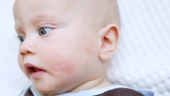 Caucasian Baby Portrait Grimacing Infant Looking to Camera Funny Face Emotions