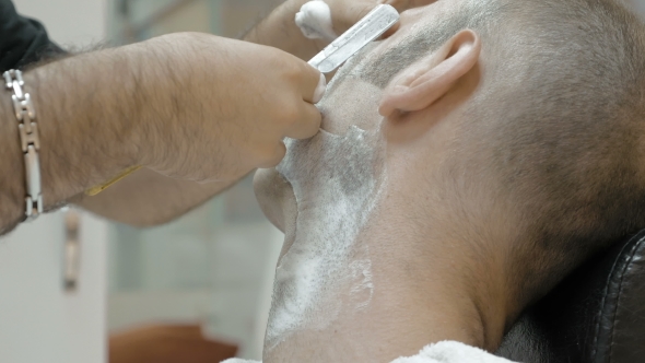 Barber Is Shaving His Client In Old Fashion Manner