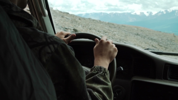 View From SUV Car Inside With Part Of Interior And Mirror With Driver Male Hand On The Steering alt