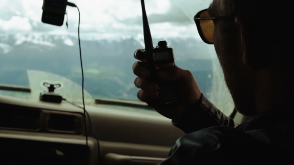 Rescuer Hitchhiker With Orange Suitcase Stopping Car On The Mountain Road