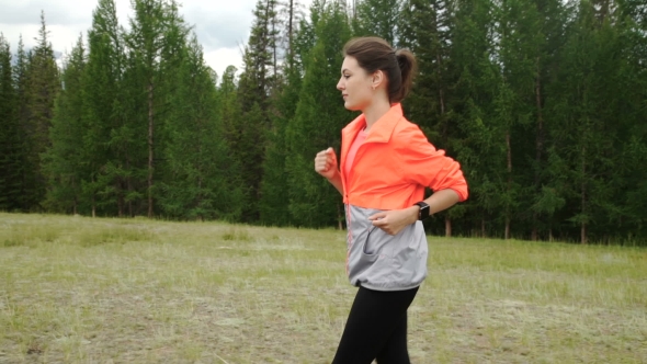 Woman Running In Wooded Forest Area, Training And Exercising For Trail Run Marathon Endurance
