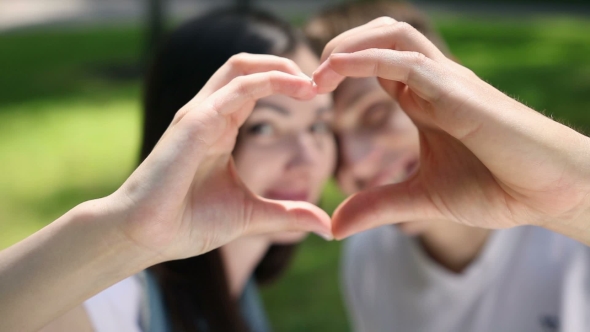 Young Couple Make a Heart Out Of Hand