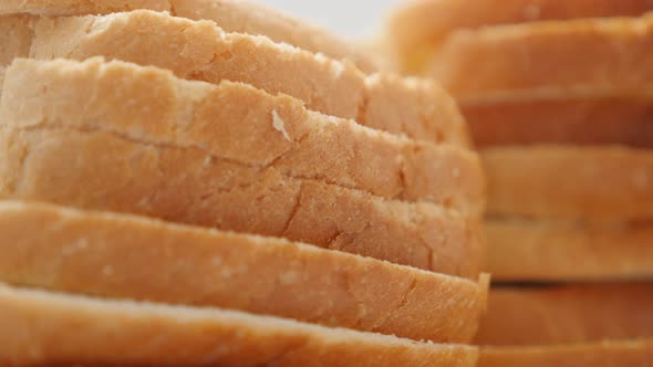 Fresh toasting bread pile healthy bread close-up slow tilt 4K 2160p 30fps UltraHD footage - Lot of t