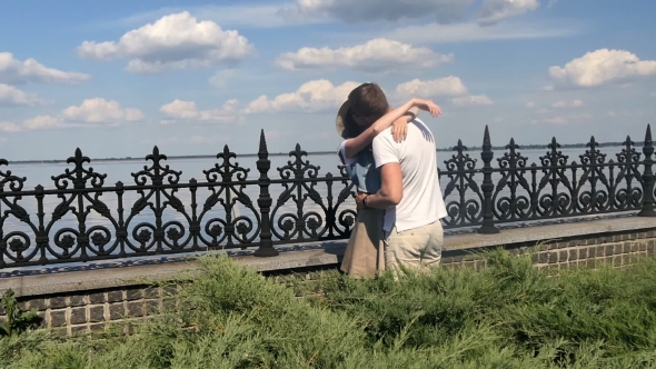 The Guy And Girl Kiss On a Background Of The River