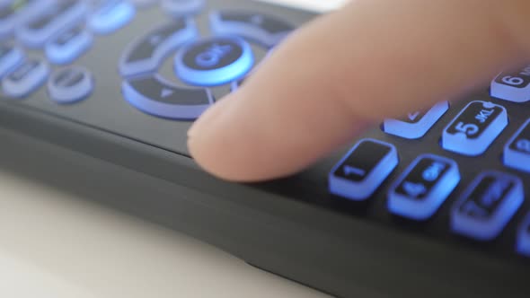 Channel changing on TV remote control close-up video