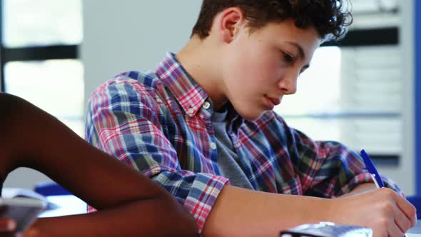 Student using mobile phone in classroom