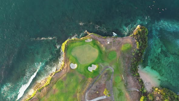 Golf Course Island Overgrown with Grass Stands in the Middle of the Ocean