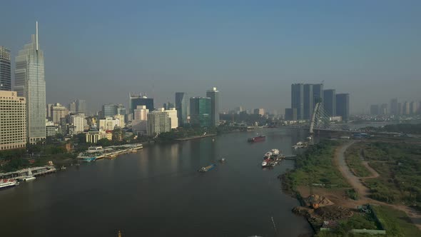 Drone view of Saigon River, Ho Chi Minh City and new Thu Thiem Bridge under construction on a sunny