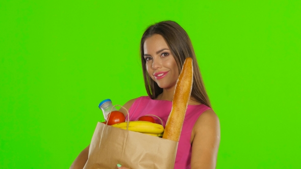 Woman Holding Bag With Groceries Food. Green Screen. 