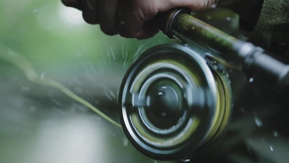 Fishing Line Spool Spinning And Splashing Water Drops