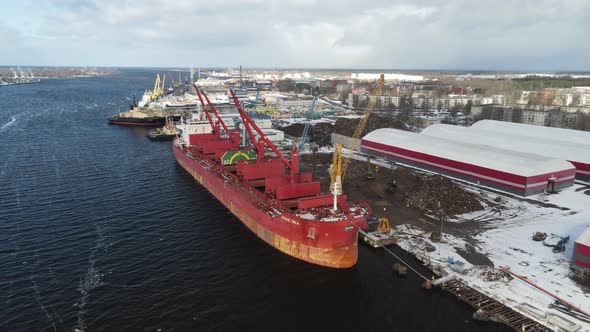 Red cargo ship in port terminal