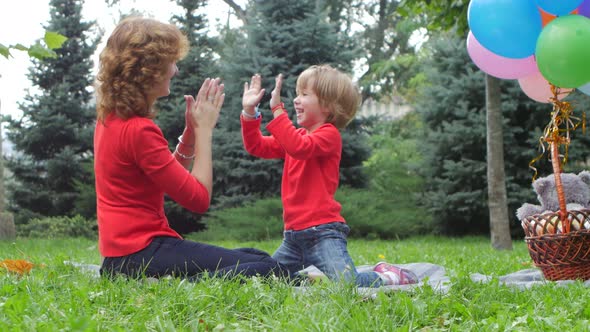 Clapping Hands - Mother Playing with Her Daughter Outdoor in Nature