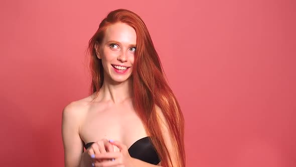 Redhaired Ginger Woman in Pinl Studio Background Useing Vibrator and Feeling Embarrassment