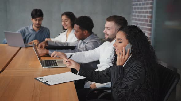 Diverse Employees Sitting in Office Hispanic Businesswoman Talking on Phone with Client Conduct