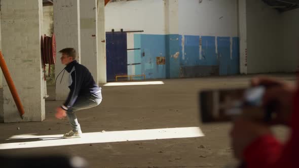 BMX rider in an empty warehouse