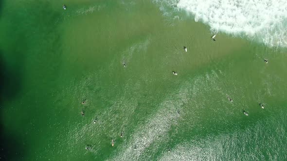 Looking straight down on surfers at a popular beach,  at Surfers Paradise,Gold Coast Australia