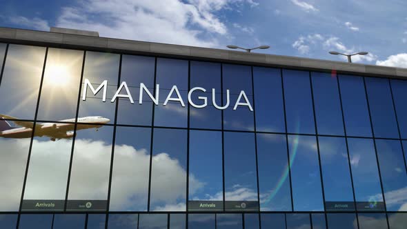 Airplane landing at Managua Nicaragua airport mirrored in terminal