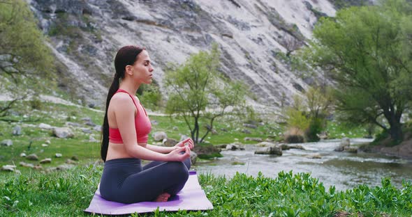 Beautiful Young Woman on the Mat in the Middle of Nature