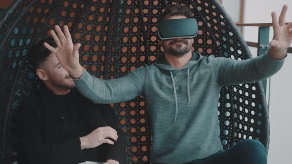 Delighted Homosexual Couple Testing the Virtual Reality Glasses at Home