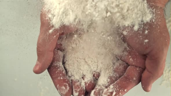 The Super Slow Motion of the Flour Falls on the Man's Hands