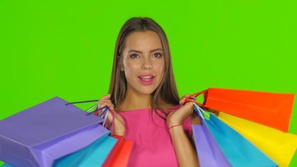 Woman Holding Shopping Bags And Smiling