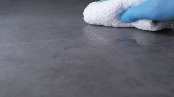 Hand in Blue Rubber Gloves Cleaning Flat Surface 