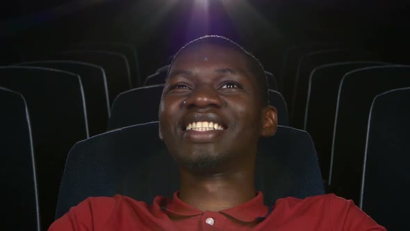 Happy African American Watching Movie In Theatre