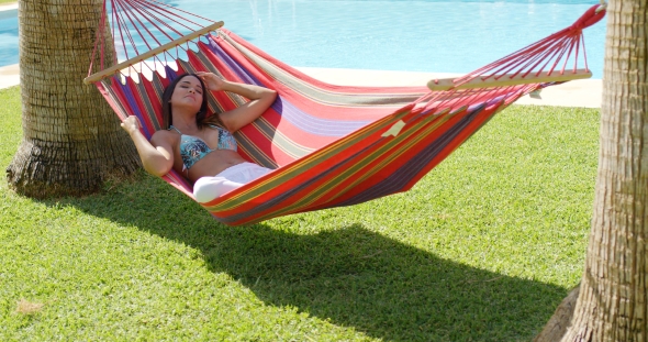 Relaxing Young Woman In Colorful Hammock