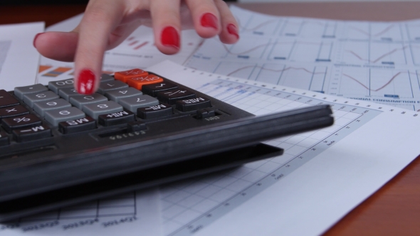 Woman Performs Calculations And Use The Calculator. 