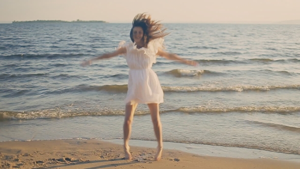 Girl Jumping On The Beach